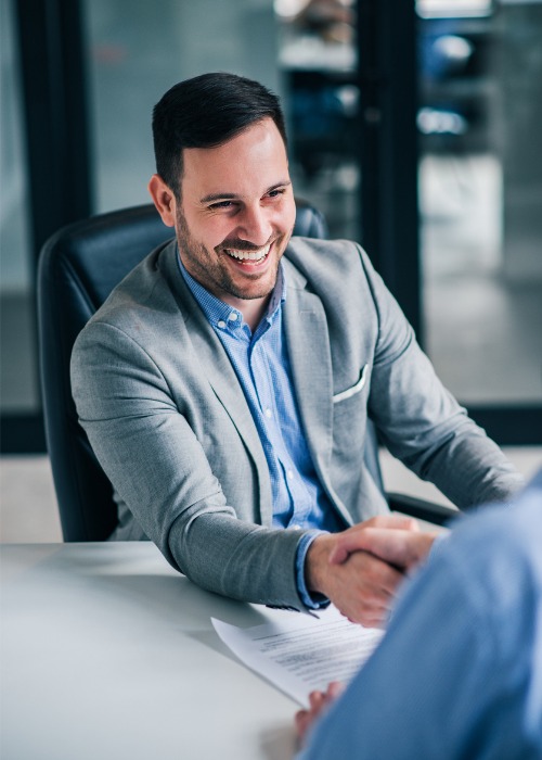 advisor shaking hands with happy client